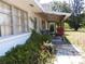 View of exterior showing patio, walkway, and lush landscaping at 1627 Umbrella Tree Dr, Edgewater, FL 32132