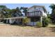Two-story home featuring a sunburst decoration above a second story balcony at 1627 Umbrella Tree Dr, Edgewater, FL 32132