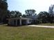 Two-story home with an attached carport, first floor porch, and second story balcony at 1627 Umbrella Tree Dr, Edgewater, FL 32132