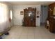 Home's foyer featuring tiled floors, a large china cabinet and natural light at 1627 Umbrella Tree Dr, Edgewater, FL 32132