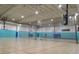 Indoor gymnasium featuring basketball hoops and a spacious court for recreational activities and sports at 1627 Umbrella Tree Dr, Edgewater, FL 32132