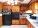 Cozy kitchen featuring wood cabinetry and modern appliances, ready for cooking and entertaining at 1627 Umbrella Tree Dr, Edgewater, FL 32132