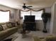 Cozy living room with comfortable seating, a ceiling fan, and a large TV at 1627 Umbrella Tree Dr, Edgewater, FL 32132