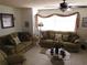 Cozy living room with tiled floor, ceiling fan, and two couches with decorative pillows at 1627 Umbrella Tree Dr, Edgewater, FL 32132