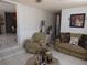 Cozy living room with wainscoting and patterned wallpaper, providing a warm and inviting atmosphere at 1627 Umbrella Tree Dr, Edgewater, FL 32132