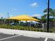 A colorful covered playground offers a shady and fun place for to play and explore at 1627 Umbrella Tree Dr, Edgewater, FL 32132