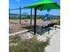 Community playground with swings, slide, and bench overlooking the water at 1627 Umbrella Tree Dr, Edgewater, FL 32132