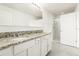 Bathroom features double vanity with granite countertops and tile floors at 1674 Coulter Ln, Port Orange, FL 32129