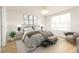 Cozy bedroom with large window, layered bedding, and bench at 1674 Coulter Ln, Port Orange, FL 32129
