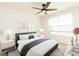 Bright bedroom with a ceiling fan, a window, and cool neutral decor at 1674 Coulter Ln, Port Orange, FL 32129