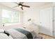Stylish bedroom with a ceiling fan, a window, and cool neutral decor at 1674 Coulter Ln, Port Orange, FL 32129