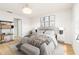 Serene bedroom featuring stylish decor, wood floors and gray bedding at 1674 Coulter Ln, Port Orange, FL 32129