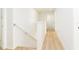 Bright hallway featuring light walls and wood floors at 1674 Coulter Ln, Port Orange, FL 32129