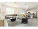 Open-concept living room adjacent to the kitchen, showcasing seamless flow, stylish decor, and abundant natural light at 1674 Coulter Ln, Port Orange, FL 32129