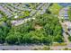Aerial view of a wooded property, surrounded by a golf course, lake, and other houses at 1786 Taylor Rd, Port Orange, FL 32128