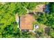 Aerial view of a house with a deck, surrounded by lush greenery providing privacy and shade at 1786 Taylor Rd, Port Orange, FL 32128