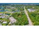 Aerial view showcasing a treed lot in a community with golf course and other housing at 1786 Taylor Rd, Port Orange, FL 32128