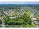 Aerial view showcasing a treed lot in a community with golf course and other housing at 1786 Taylor Rd, Port Orange, FL 32128