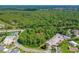 Aerial view showcasing a treed lot in a community with golf course and other housing at 1786 Taylor Rd, Port Orange, FL 32128