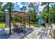 Outdoor deck with a shaded dining area and seating, ideal for relaxation and entertainment at 1786 Taylor Rd, Port Orange, FL 32128