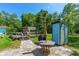 Outdoor area featuring a table, seating, shed and grill, perfect for entertaining at 1786 Taylor Rd, Port Orange, FL 32128