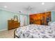 Relaxing bedroom with accent mural, tiled floor, ceiling fan, and decorative furnishings at 1786 Taylor Rd, Port Orange, FL 32128