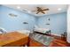 Well-lit bedroom featuring hardwood floors, beds with sea-themed bedding, and aquatic themed decor at 1786 Taylor Rd, Port Orange, FL 32128