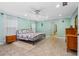 Comfortable bedroom with a ceiling fan, tile floors, and calming paint at 1786 Taylor Rd, Port Orange, FL 32128