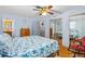 Inviting bedroom with hardwood floors, closet, and a bed dressed in blue seashell-themed bedding at 1786 Taylor Rd, Port Orange, FL 32128