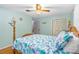 Charming bedroom featuring a ceiling fan and a bed with blue sea-themed bedding at 1786 Taylor Rd, Port Orange, FL 32128