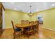 Spacious dining room with hardwood floors, a traditional chandelier and ample seating for eight at 1786 Taylor Rd, Port Orange, FL 32128