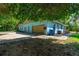 Charming home featuring a two-car garage and a long driveway for easy parking at 1786 Taylor Rd, Port Orange, FL 32128