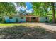 Charming one-story home with brick accents, blue door, blue siding and a spacious front yard at 1786 Taylor Rd, Port Orange, FL 32128