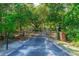 Private driveway with brick columns, a metal gate and lush greenery at 1786 Taylor Rd, Port Orange, FL 32128