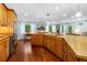 Gourmet kitchen with island cooktop, custom cabinets, and views of the yard at 1786 Taylor Rd, Port Orange, FL 32128