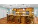 Spacious kitchen island with seating, complemented by wood cabinets and stainless steel appliances at 1786 Taylor Rd, Port Orange, FL 32128