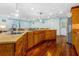 Open concept kitchen with wood cabinets, stainless steel appliances and hardwood floors at 1786 Taylor Rd, Port Orange, FL 32128