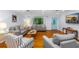 Bright living room showcasing large window with backyard view, hardwood floors, and neutral decor at 1786 Taylor Rd, Port Orange, FL 32128