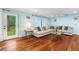 Spacious living room showcasing hardwood floors, natural light, and access to the backyard at 1786 Taylor Rd, Port Orange, FL 32128