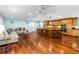 Bright open-concept living room flows into the kitchen, featuring hardwood floors and a comfortable seating area at 1786 Taylor Rd, Port Orange, FL 32128