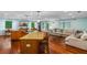 Open living space with hardwood floors, modern island, and abundant natural light at 1786 Taylor Rd, Port Orange, FL 32128