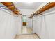 Spacious walk-in closet with built-in shelving and a view leading to the bathroom with tiled flooring at 1786 Taylor Rd, Port Orange, FL 32128