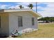 Side view of brick house featuring side windows and a lush green lawn at 1830 Needle Palm Dr, Edgewater, FL 32132