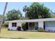 Charming single-story home with white brick exterior and well-maintained lawn at 1830 Needle Palm Dr, Edgewater, FL 32132
