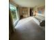 Bright living room with a large window, sofa, and display cabinet at 1830 Needle Palm Dr, Edgewater, FL 32132