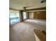 Spacious living room with sliding glass doors, neutral carpet, and ample natural light creates a relaxing atmosphere at 1830 Needle Palm Dr, Edgewater, FL 32132