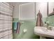 Bathroom featuring a pedestal sink with a jade green tiled wall and a shower curtain at 184 Azalea Rd, Edgewater, FL 32141