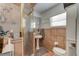 Cozy bathroom with tiled shower, pedestal sink, and warm, neutral color scheme at 184 Azalea Rd, Edgewater, FL 32141