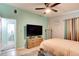 Bedroom featuring a flat screen tv on a dresser and an adjacent bathroom at 184 Azalea Rd, Edgewater, FL 32141