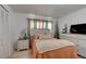 Cozy bedroom featuring a comfortable bed with a decorative throw and light colored furniture at 184 Azalea Rd, Edgewater, FL 32141